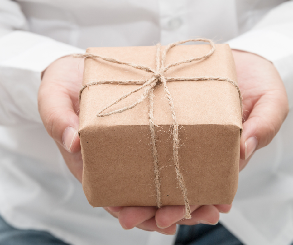 Grateful hearts charity holding wrapped box Eid City Canada